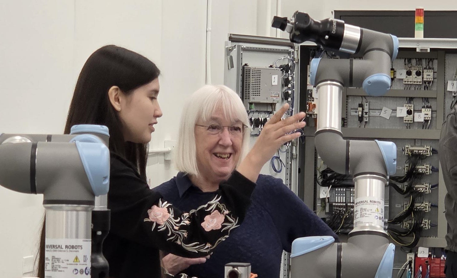 Sen. Patty Murray smiles as Mechatronics student Elizabeth Roa lets her control a robot in the Mechatronics lab.