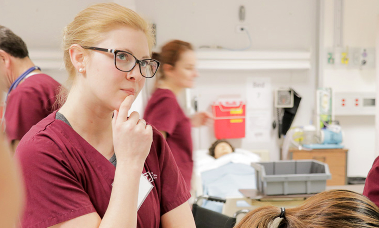 A nursing student thinking in a nursing classroom